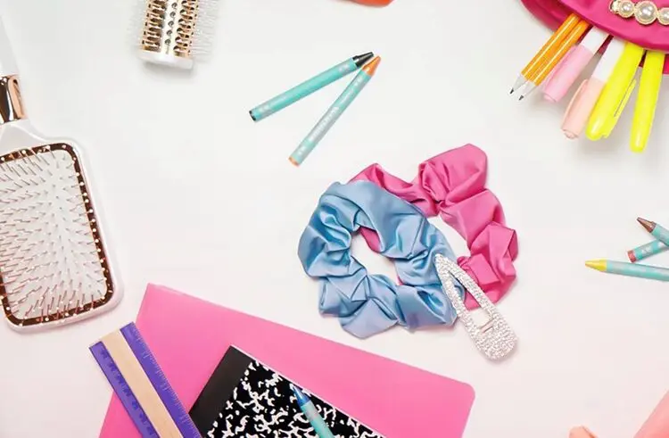 A table with some hair ties and pencils